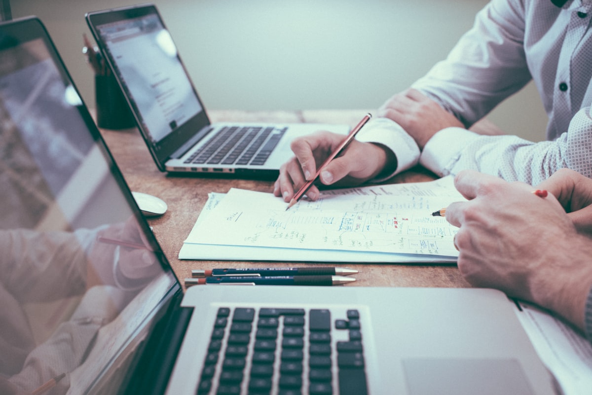 Signing a Commercial Property Contract Buyer signing a commercial property contract with a pen and documents on the table