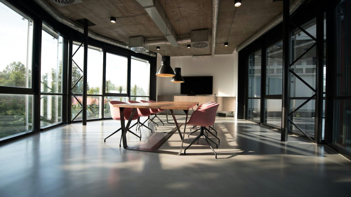 Modern corporate office interior in Lahore with a team meeting around a glass table